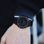 Black watch on a wrist with a blurred background